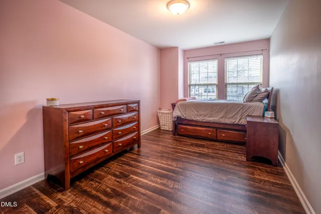 a bedroom with furniture and wooden floor