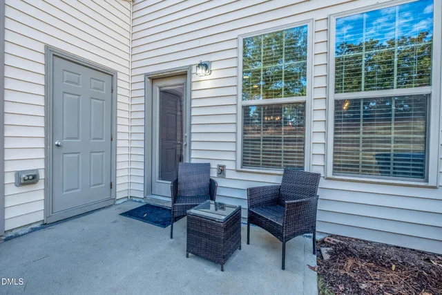 a wooden bench sitting in front of a house