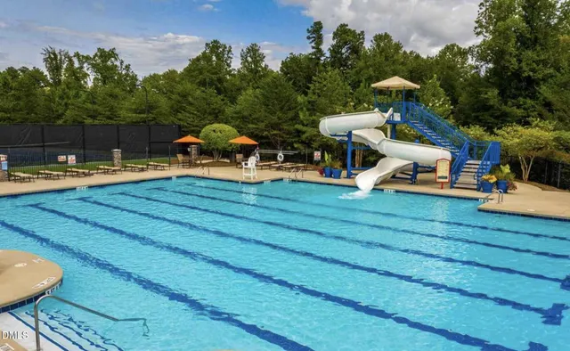 a view of a swimming pool with lounge chairs