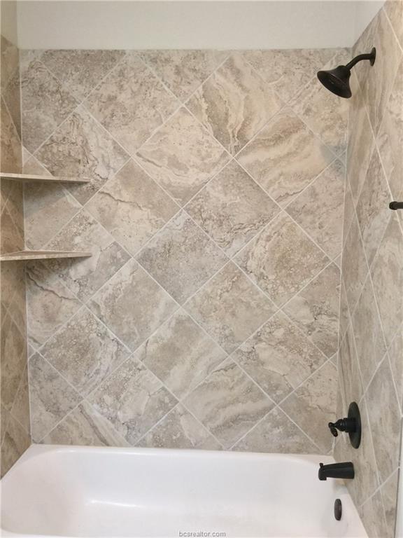 109 Ehlinger Drive Bryan, TX 77801 - Photo 16 of 25 a bathroom with a bathtub