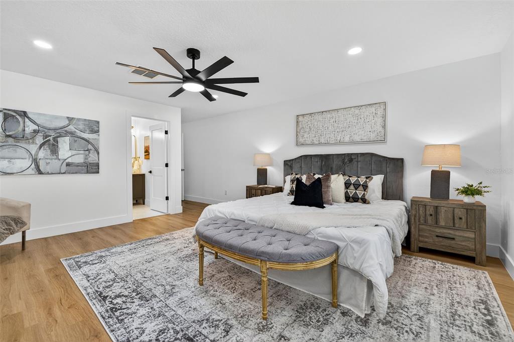1120 Country Lane Lutz, FL 33558 - Photo 24 of 52 a bedroom with a bed and a dresser