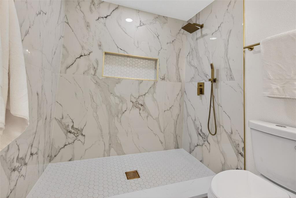 1120 Country Lane Lutz, FL 33558 - Photo 28 of 52 a bathroom with a toilet and shower