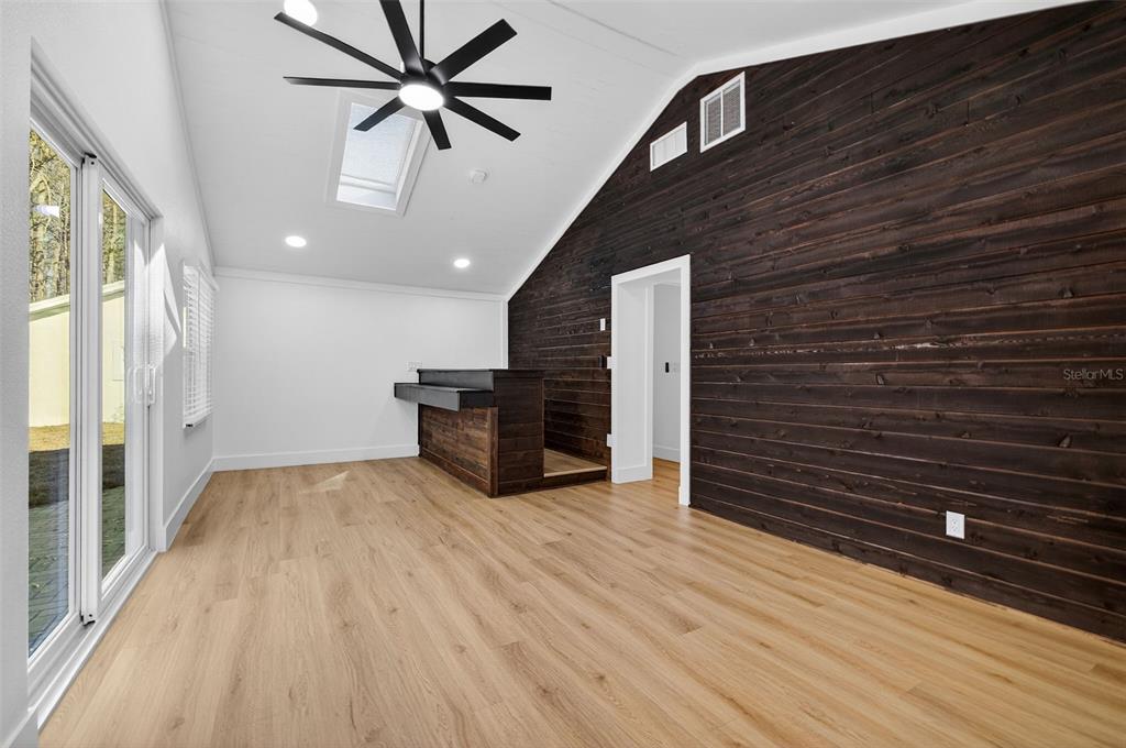 1120 Country Lane Lutz, FL 33558 - Photo 29 of 52 a view of an empty room with wooden floor and a ceiling fan