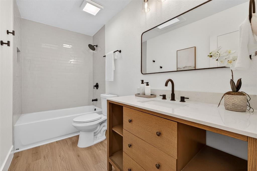 1120 Country Lane Lutz, FL 33558 - Photo 35 of 52 a bathroom with a double vanity sink toilet mirror and bathtub