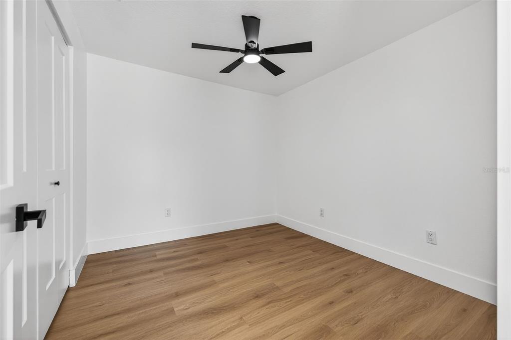 1120 Country Lane Lutz, FL 33558 - Photo 36 of 52 a view of a room with wooden floor and a ceiling fan
