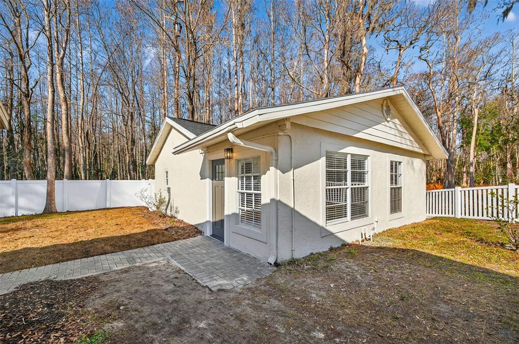 1120 Country Lane Lutz, FL 33558 - Photo 38 of 52 a view of a house with a backyard and trees
