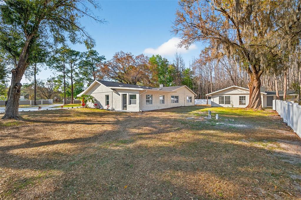 1120 Country Lane Lutz, FL 33558 - Photo 6 of 52 a view of small white house with large trees