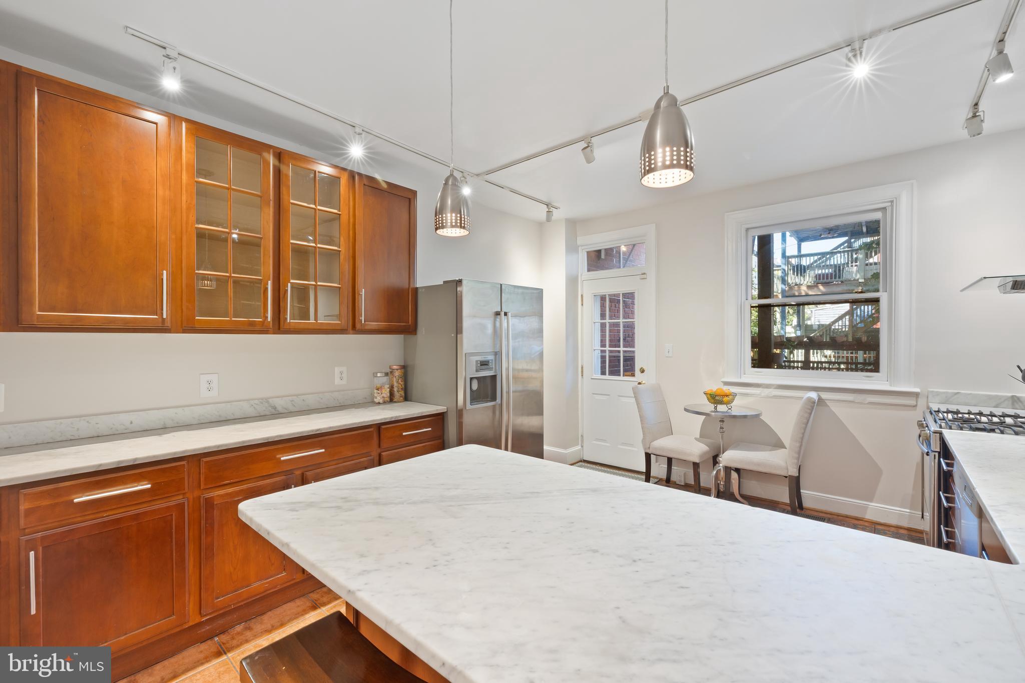 2724 13th Street Northwest Washington, DC 20009 - Photo 11 of 49 a bedroom with a large bed a chandelier and windows
