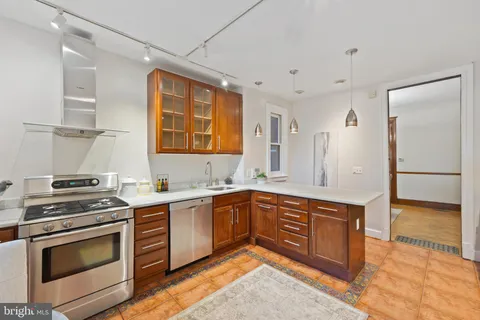 a kitchen with stainless steel appliances granite countertop a stove and a sink