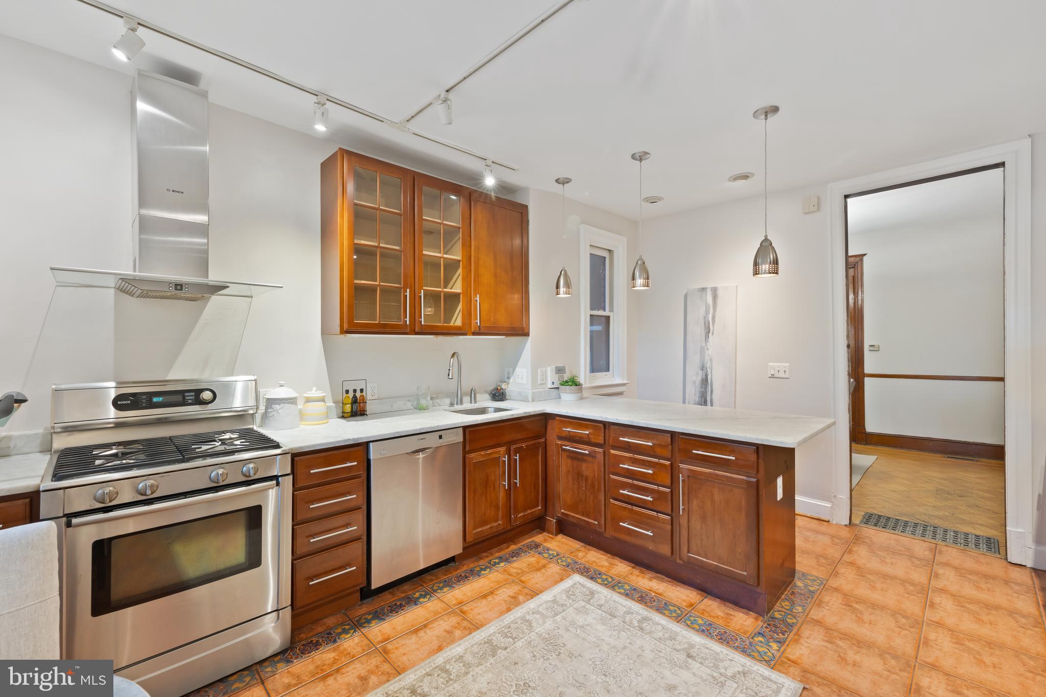2724 13th Street Northwest Washington, DC 20009 - Photo 12 of 49 a kitchen with stainless steel appliances granite countertop a stove and a sink