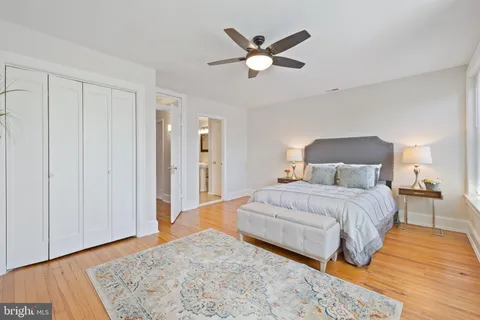 a bedroom with a large bed and a chandelier