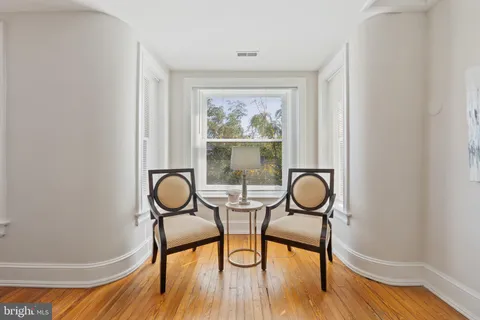 a view of a room with gym equipment and wooden floor