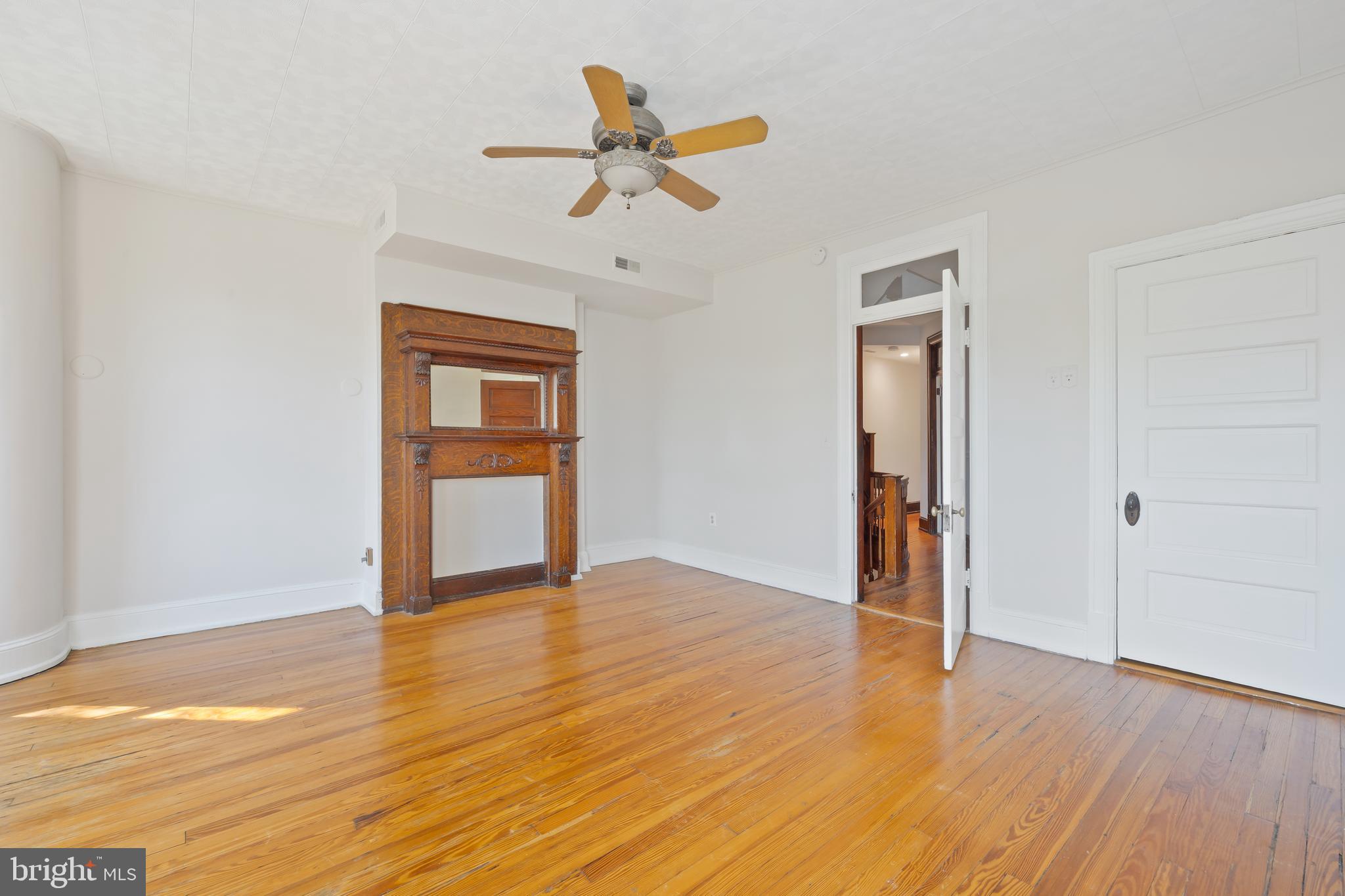2724 13th Street Northwest Washington, DC 20009 - Photo 24 of 49 a view of an empty room with wooden floor and a ceiling fan
