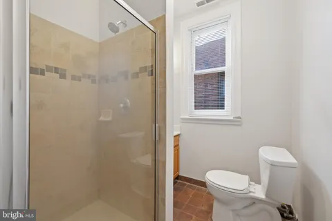a bathroom with a toilet and a shower