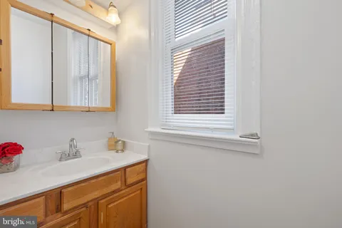 a bathroom with a sink and a window