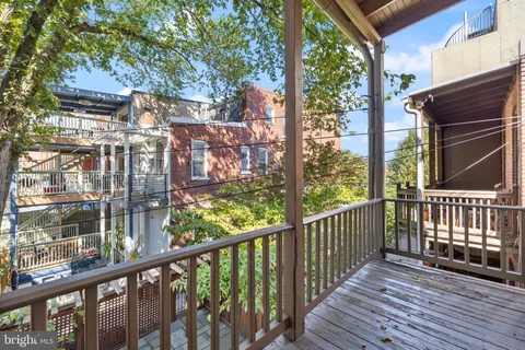 a view of a balcony with wooden floor