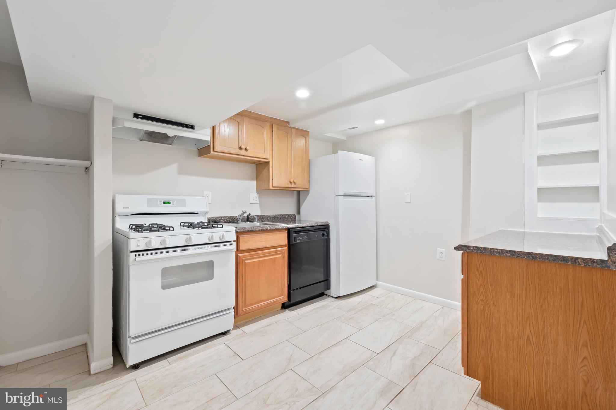 2724 13th Street Northwest Washington, DC 20009 - Photo 38 of 49 a kitchen with a stove top oven and cabinets