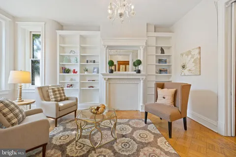 a living room with furniture and a chandelier