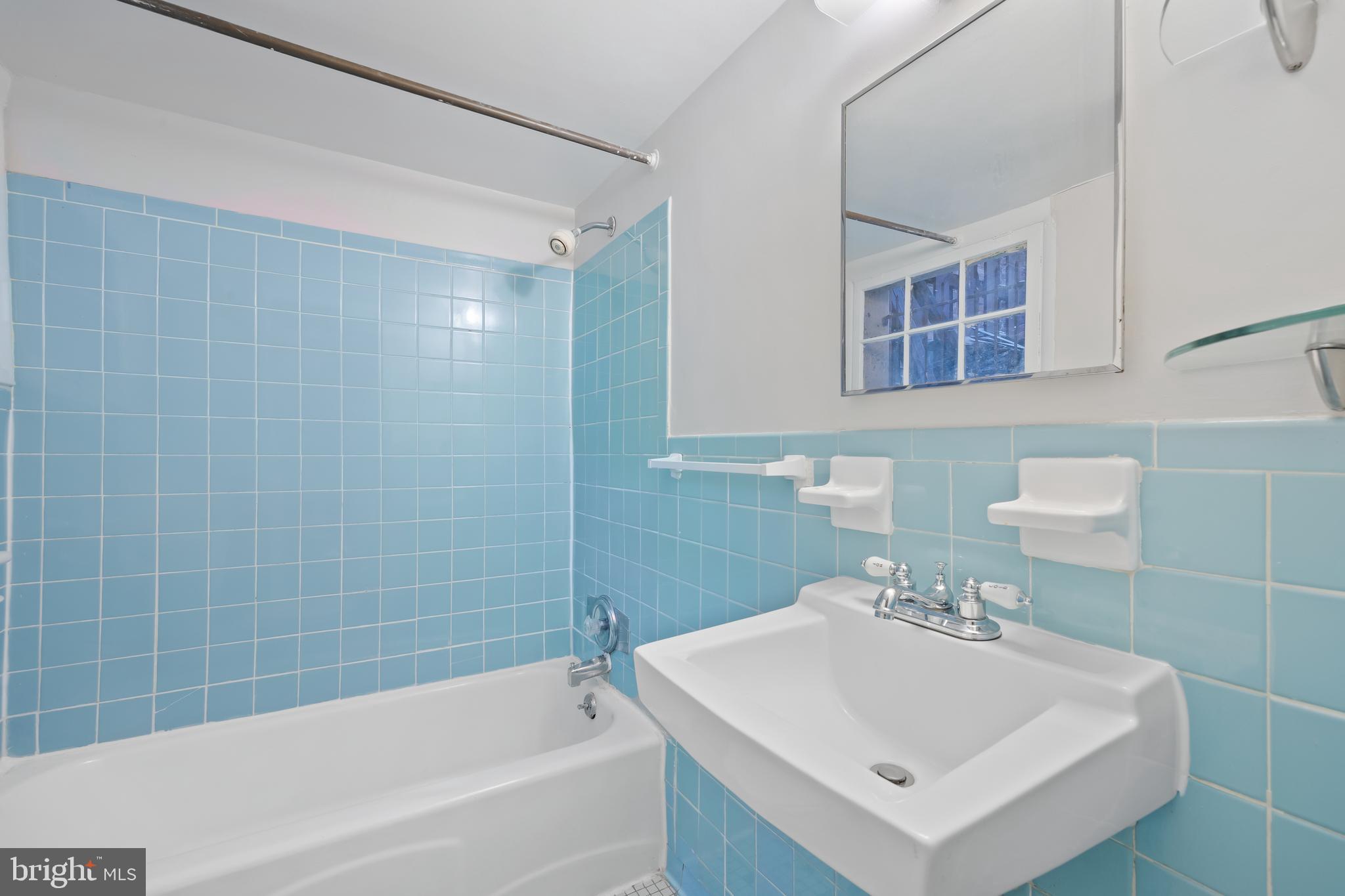 2724 13th Street Northwest Washington, DC 20009 - Photo 44 of 49 a bathroom with a sink mirror and a bathtub