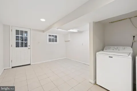 an empty room with white walls and tiles