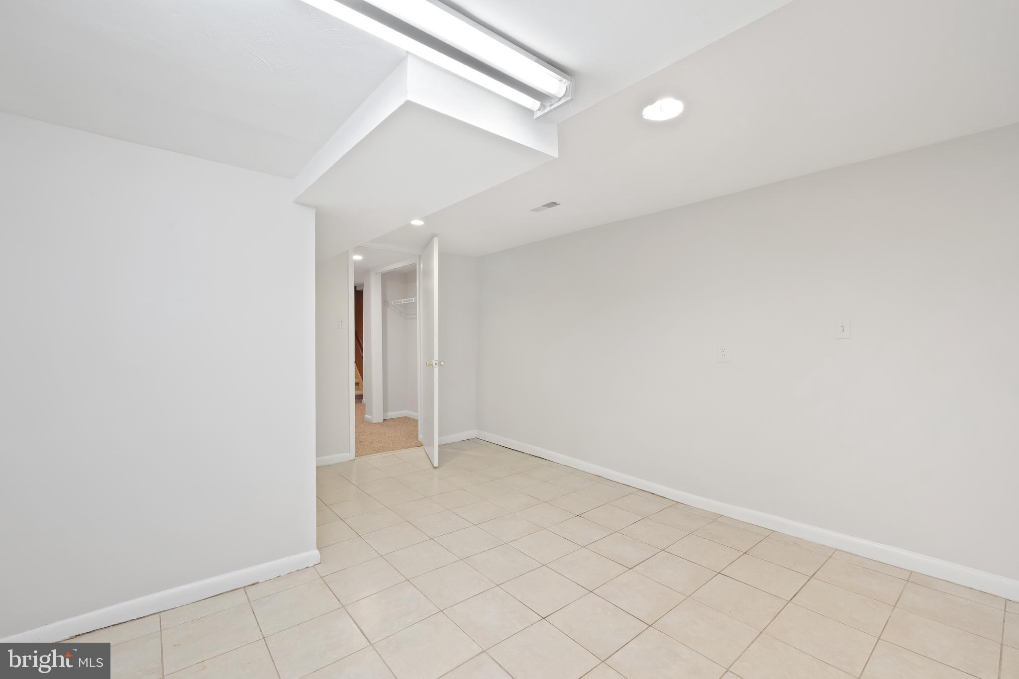 2724 13th Street Northwest Washington, DC 20009 - Photo 47 of 49 an empty room with white walls and tiles