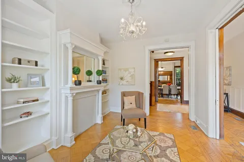 a living room with furniture and a chandelier