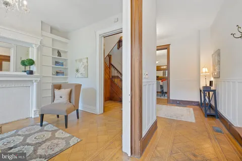 a view of a hallway to a livingroom and a chair