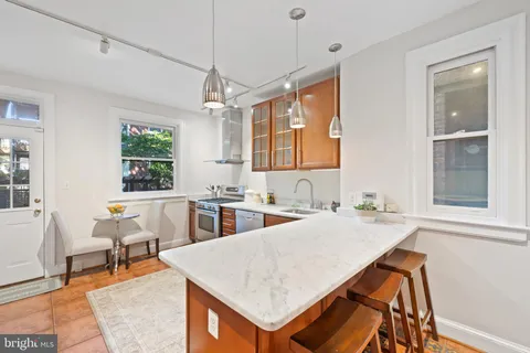 a very nice looking dining room with a large window and dining table