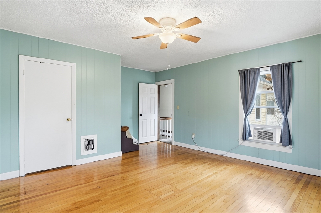 21 Whitman Street Leominster, MA 01453 - Photo 14 of 34 a view of an empty room with window and wooden floor