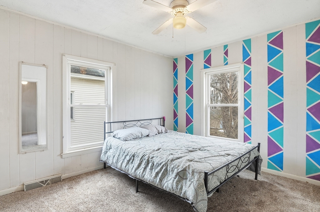 21 Whitman Street Leominster, MA 01453 - Photo 15 of 34 a bedroom with a bed and a painting on the wall