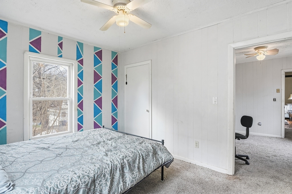 21 Whitman Street Leominster, MA 01453 - Photo 17 of 34 a bedroom with a bed and a painting on the wall