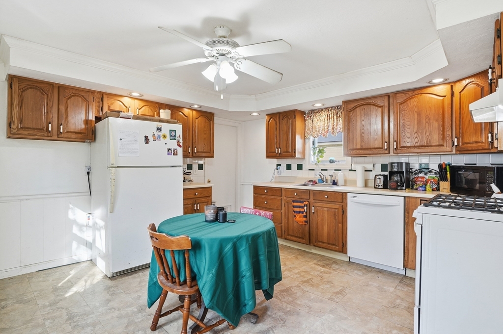21 Whitman Street Leominster, MA 01453 - Photo 8 of 34 a kitchen with a refrigerator a stove a sink and cabinets