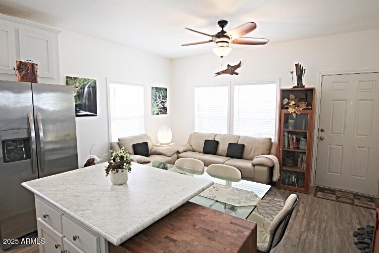 1837 North Thornton Road, Unit 45 Casa Grande, AZ 85122 - Photo 3 of 11 a living room with furniture a chandelier and a dining table with wooden floor