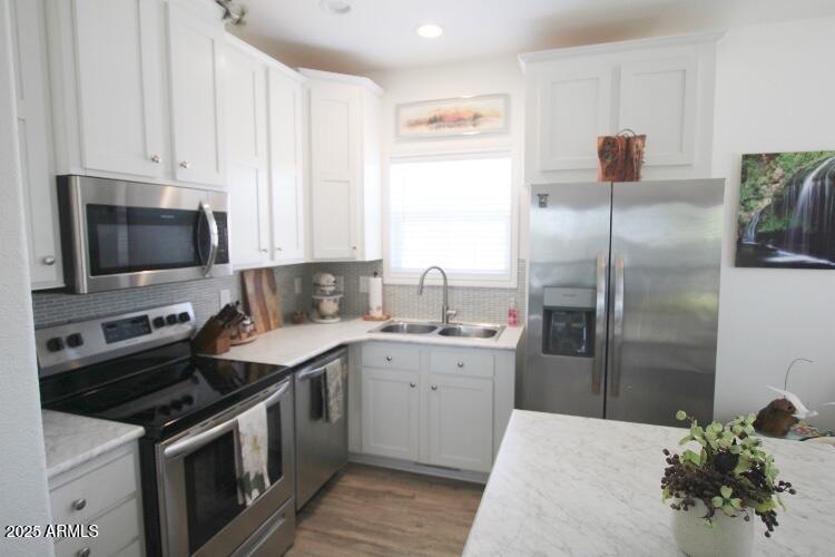 1837 North Thornton Road, Unit 45 Casa Grande, AZ 85122 - Photo 4 of 11 a kitchen with stainless steel appliances granite countertop a sink stove and refrigerator