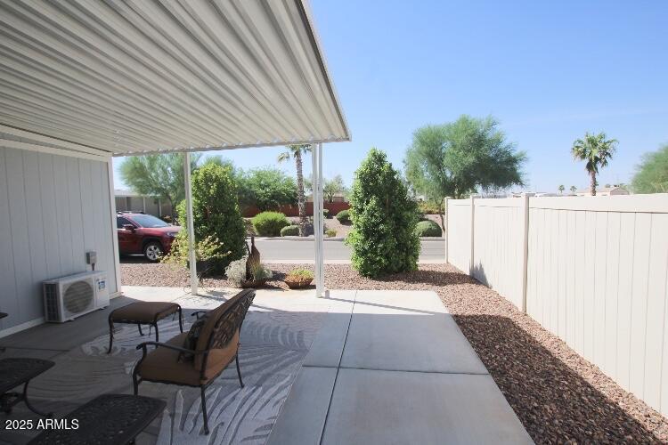 1837 North Thornton Road, Unit 45 Casa Grande, AZ 85122 - Photo 9 of 11 a view of a patio with table and chairs under an umbrella