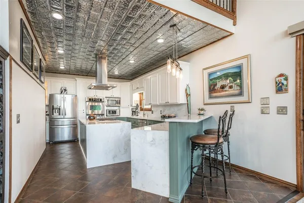 a kitchen with refrigerator and cabinets