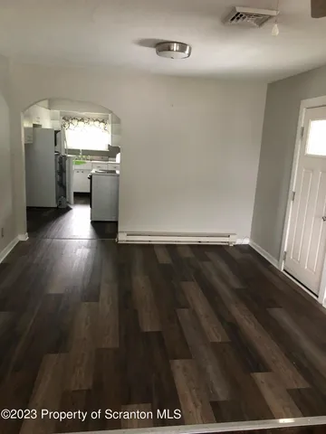 wooden floor in an empty room and a kitchen