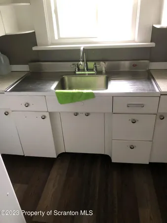 a view of a room with wooden floor and a window