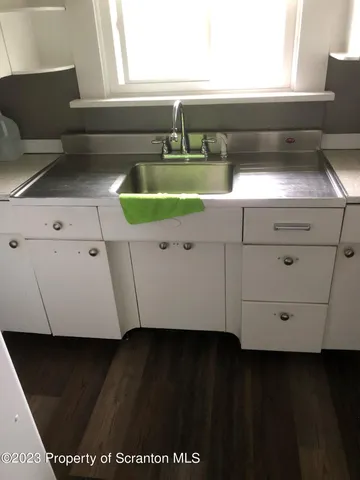a view of a room with wooden floor and a window