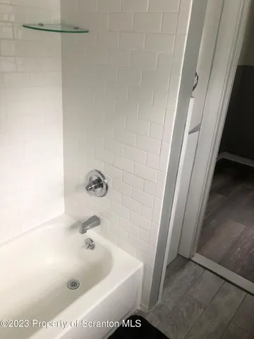 a bathroom with a toilet and a picture