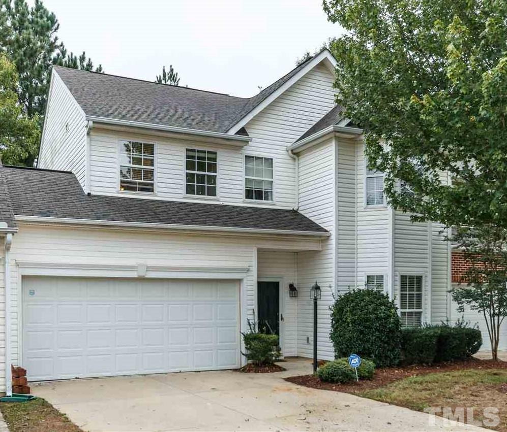 1035 Lake Moraine Place Raleigh, NC 27607 - Photo 1 of 19 a front view of a house with a garden
