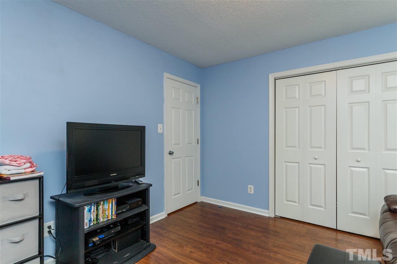 1035 Lake Moraine Place Raleigh, NC 27607 - Photo 13 of 19 a living room with flat screen tv and wooden floor