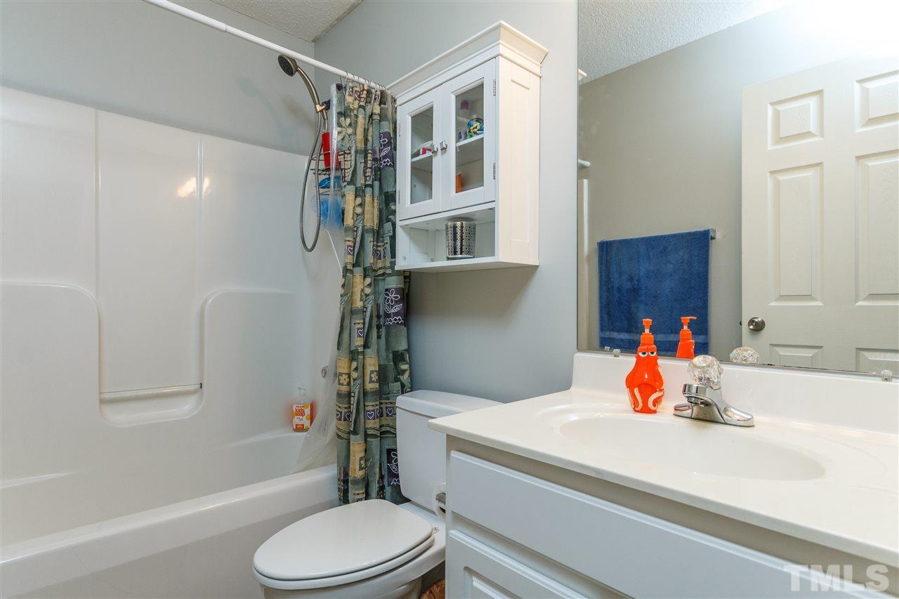 1035 Lake Moraine Place Raleigh, NC 27607 - Photo 14 of 19 a bathroom with a sink toilet tub and shower