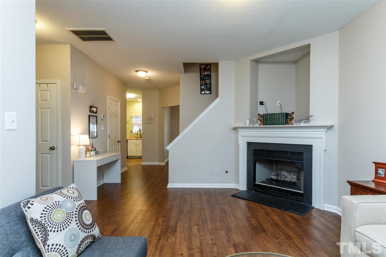 1035 Lake Moraine Place Raleigh, NC 27607 - Photo 4 of 19 a living room with furniture and a fireplace
