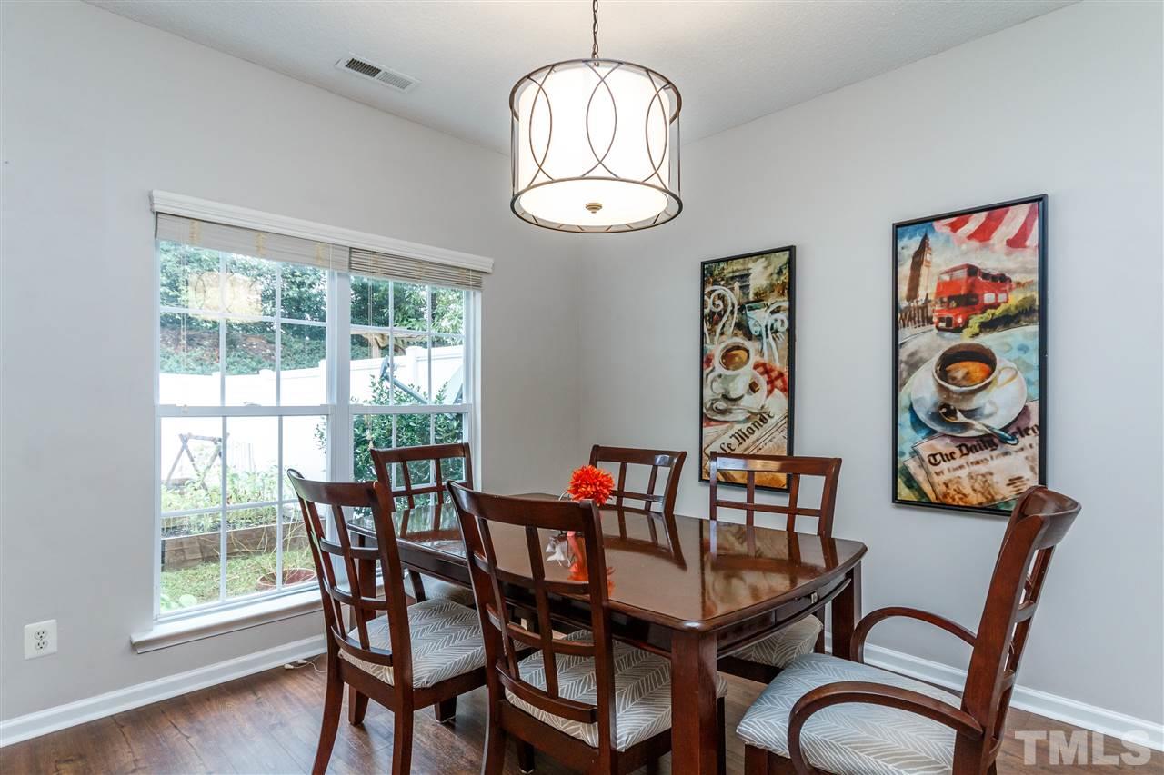 1035 Lake Moraine Place Raleigh, NC 27607 - Photo 5 of 19 a view of a dining room with furniture window and wooden floor