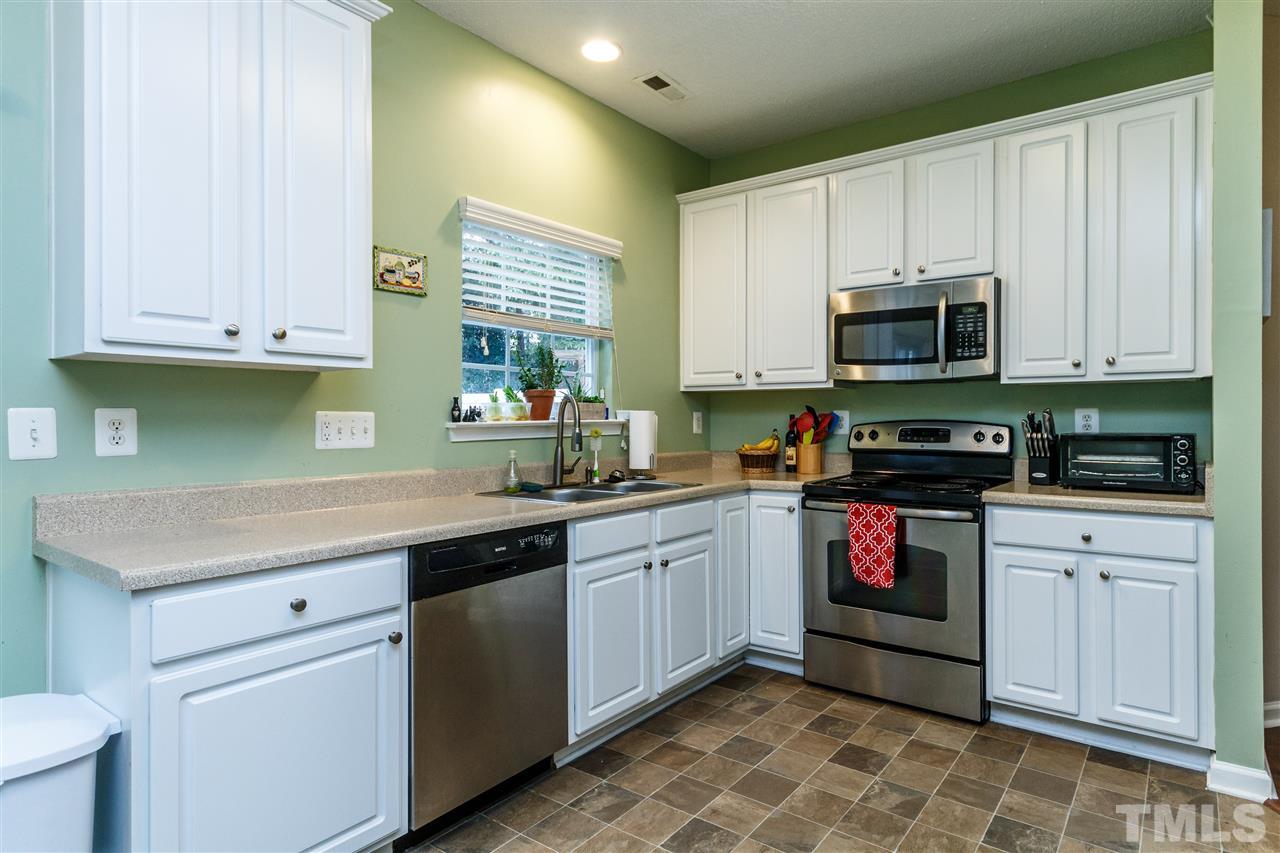1035 Lake Moraine Place Raleigh, NC 27607 - Photo 6 of 19 a kitchen with stainless steel appliances granite countertop a sink and cabinets