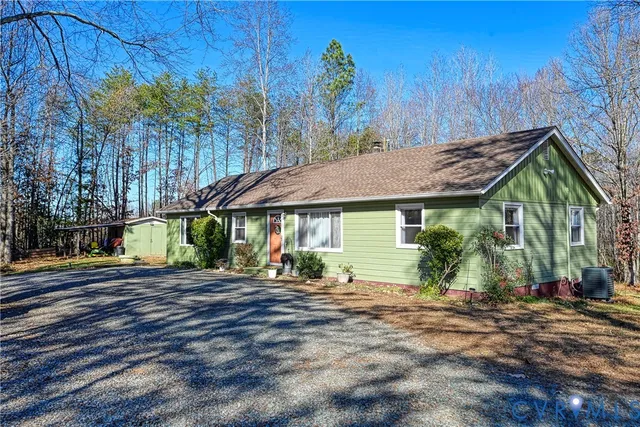 a view of a house with a yard and sitting area