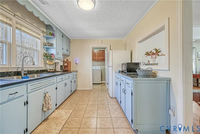 a large kitchen with stainless steel appliances a sink and cabinets