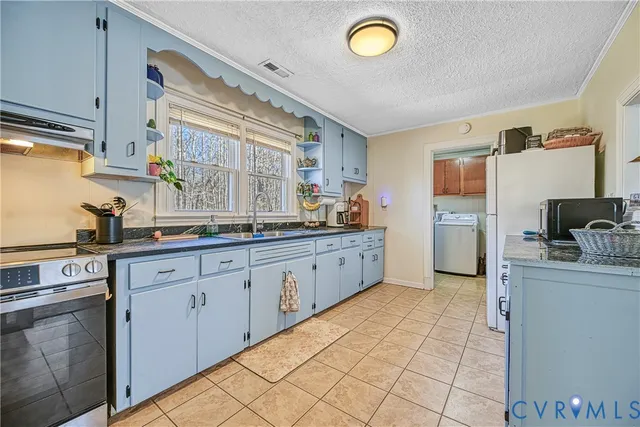 a kitchen with stainless steel appliances granite countertop a sink and cabinets