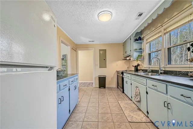 a large white kitchen with granite countertop a sink